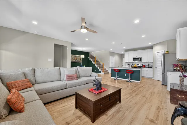 a living room with furniture and kitchen view
