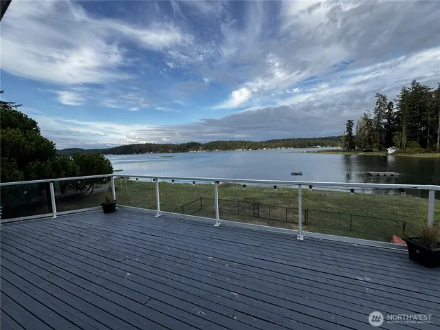 a view of a terrace with wooden floor and lake view