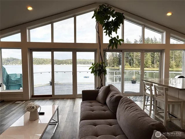 a living room with furniture and floor to ceiling windows