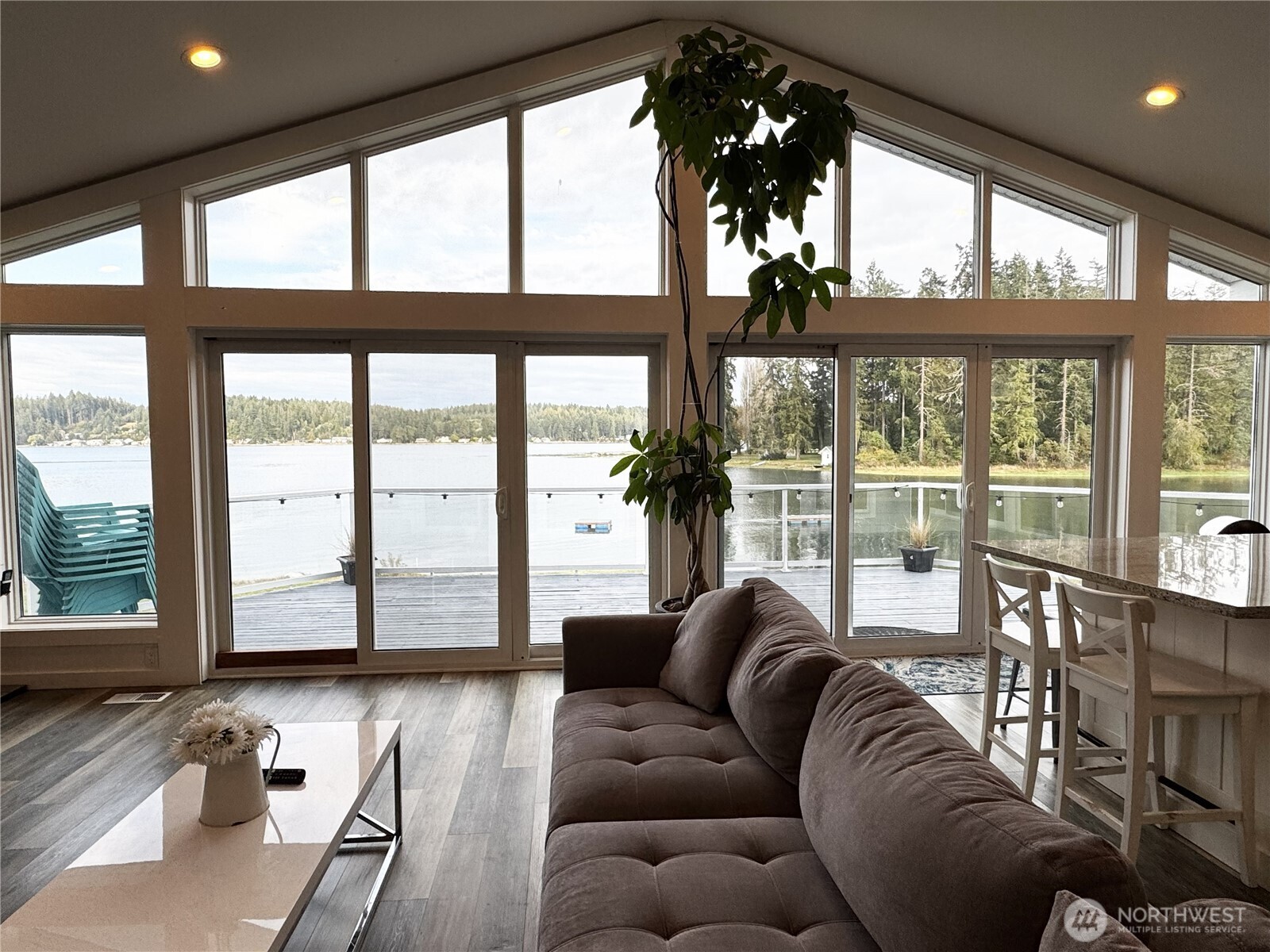 7360 East Grapeview Loop Road Allyn, WA 98524 - Photo 5 of 19 a living room with furniture and floor to ceiling windows