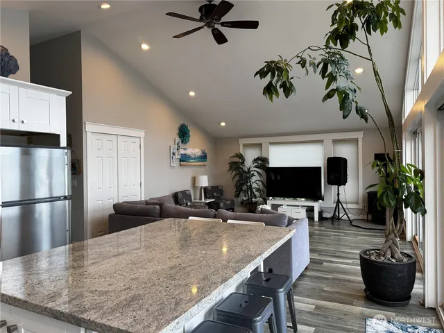 a living room with furniture and a potted plant