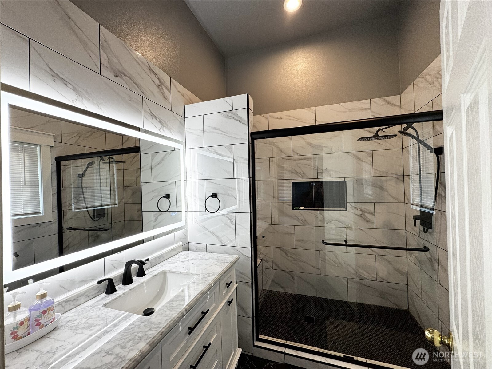 7360 East Grapeview Loop Road Allyn, WA 98524 - Photo 9 of 19 a bathroom with a shower sink and mirror