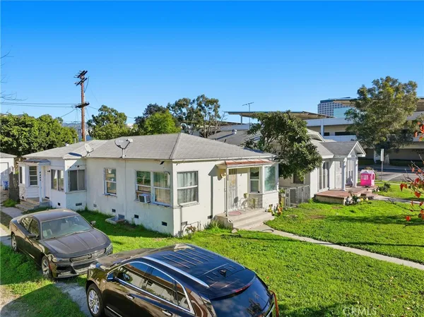 a view of a house with a backyard and a patio