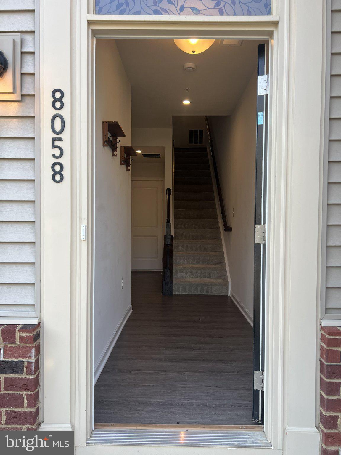 8058 Big Roundtop Road Fort George G Meade, MD 20755 - Photo 3 of 24 a view of a hallway with wooden floor and entryway