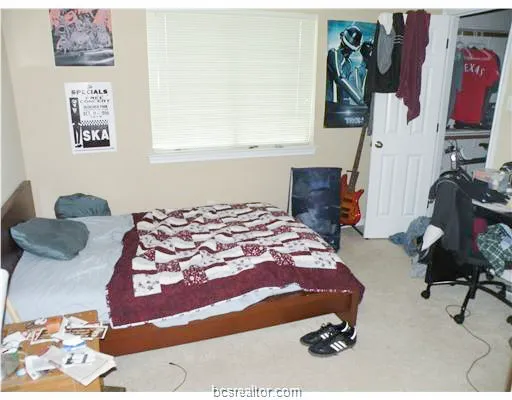 a bedroom with a bed and a window