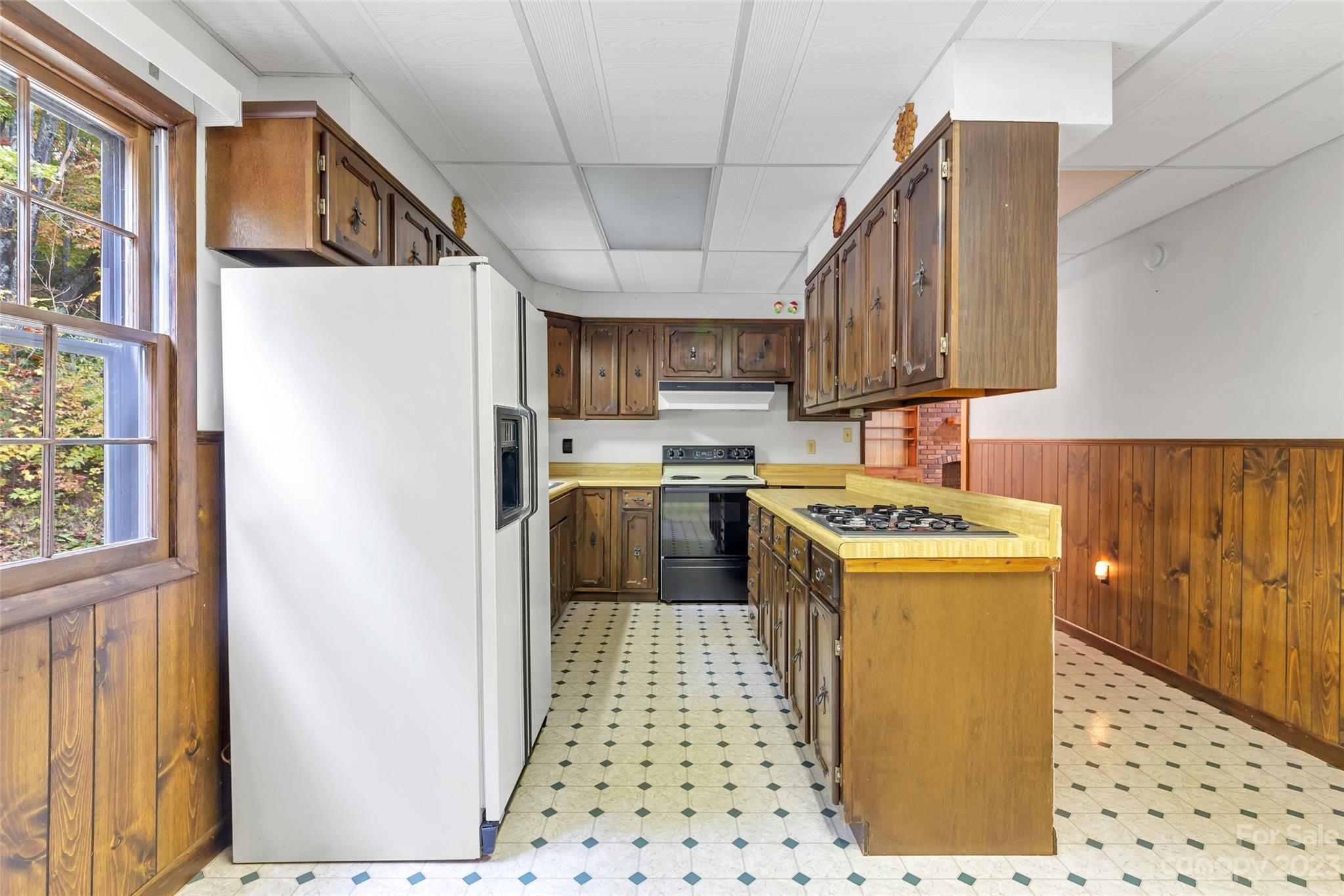 91 Chestnut Hill Road Black Mountain, NC 28711 - Photo 14 of 45 a kitchen with a sink a stove top oven a refrigerator and cabinets