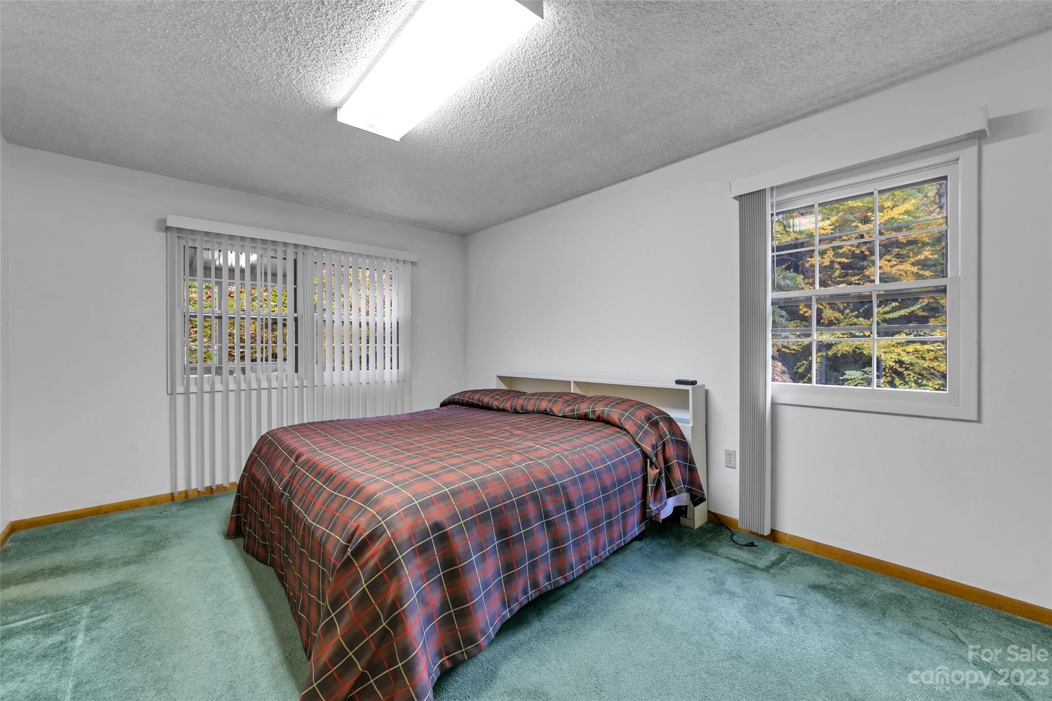 91 Chestnut Hill Road Black Mountain, NC 28711 - Photo 17 of 45 a bedroom with a bed lamp and window