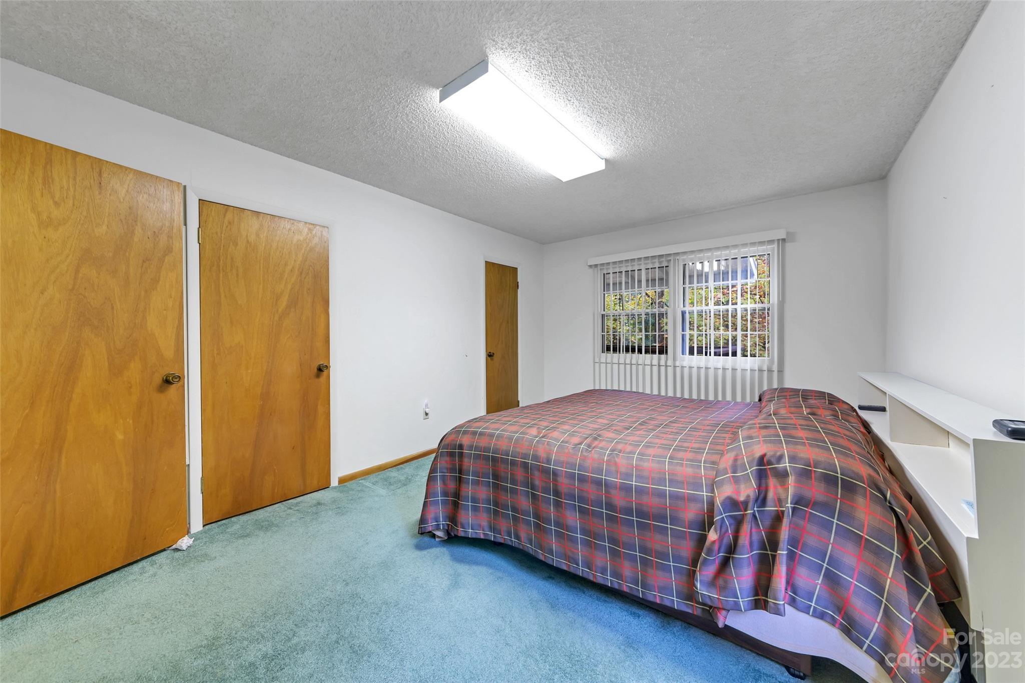 91 Chestnut Hill Road Black Mountain, NC 28711 - Photo 19 of 45 a bedroom with a bed and a window