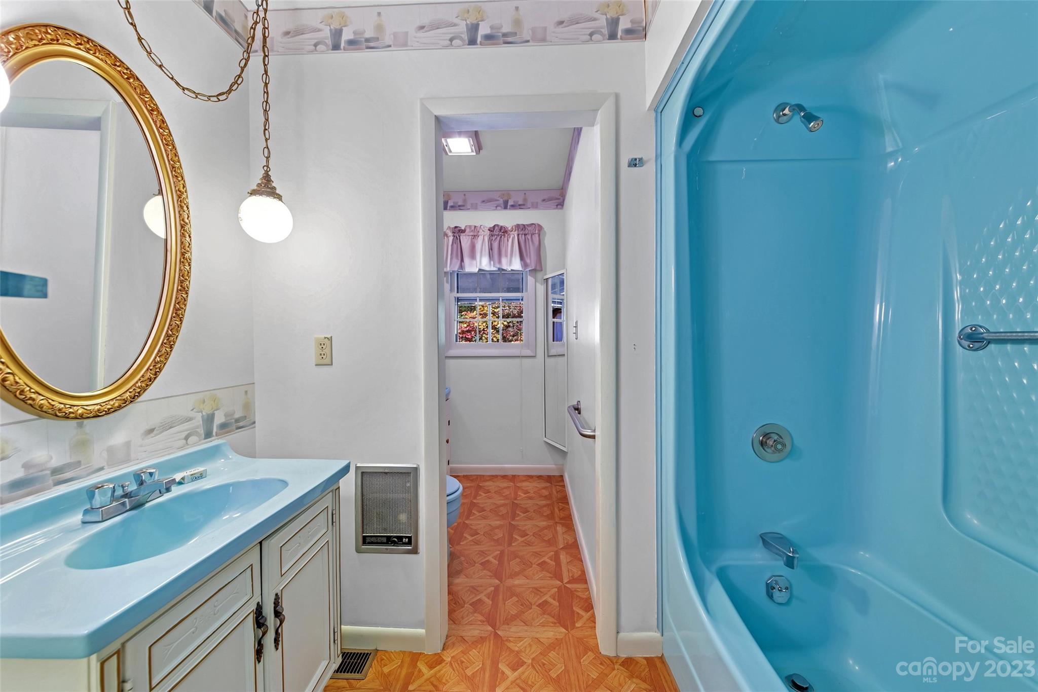91 Chestnut Hill Road Black Mountain, NC 28711 - Photo 20 of 45 a bathroom with a granite countertop sink a mirror a bathtub and shower