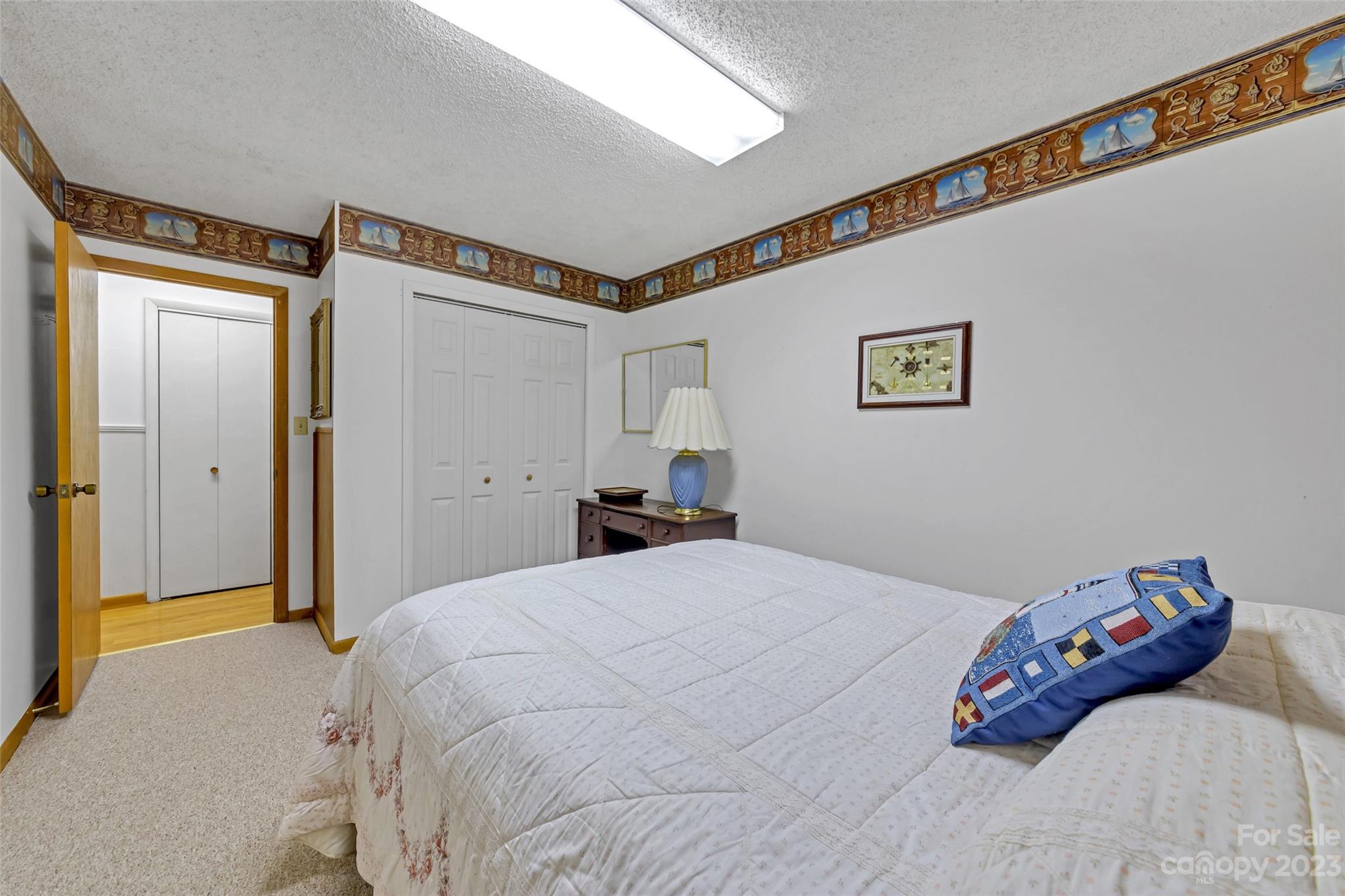 91 Chestnut Hill Road Black Mountain, NC 28711 - Photo 23 of 45 a bedroom with a bed and a painting on the wall