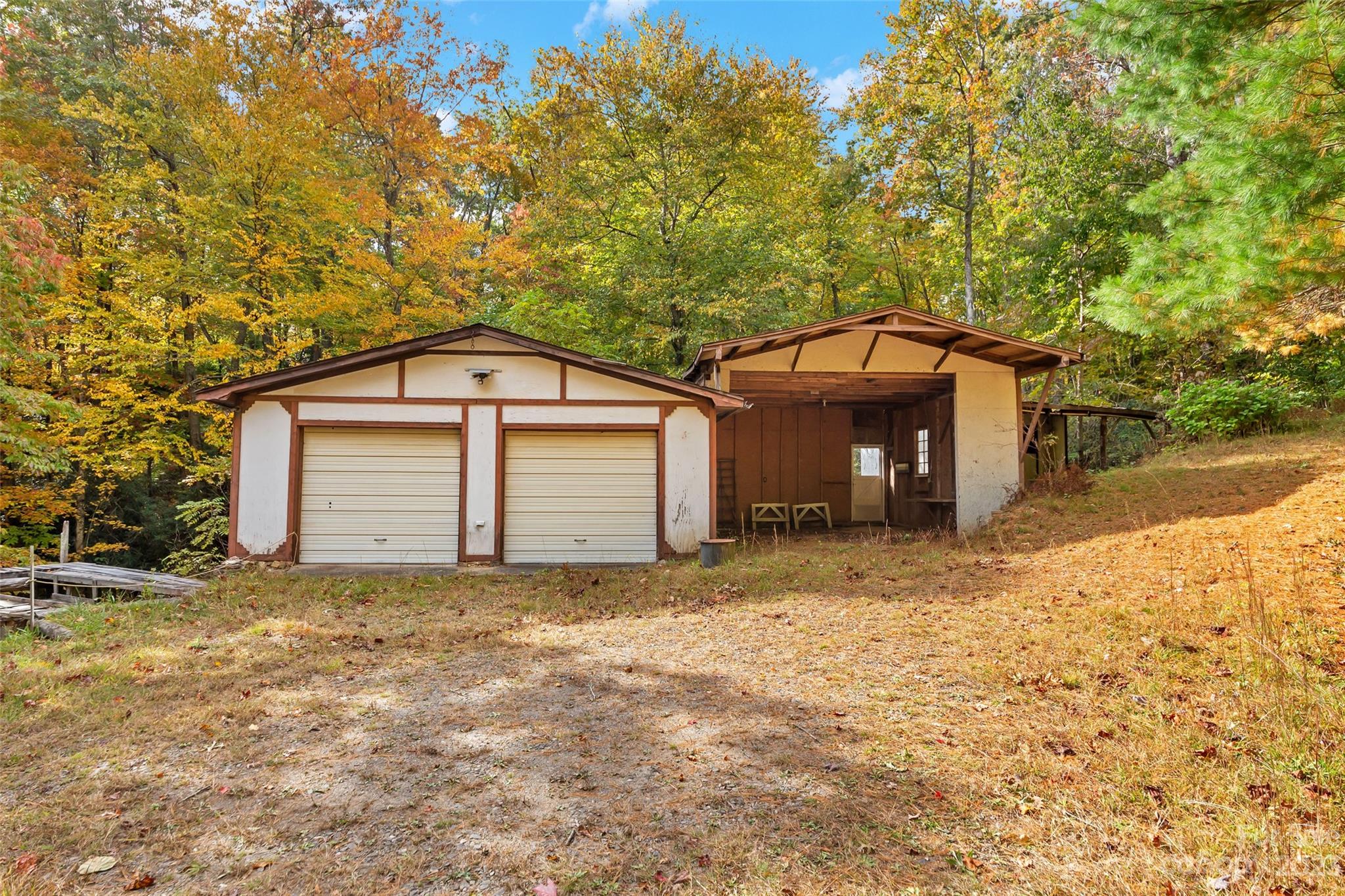 91 Chestnut Hill Road Black Mountain, NC 28711 - Photo 40 of 45 a view of a house with a yard and garage