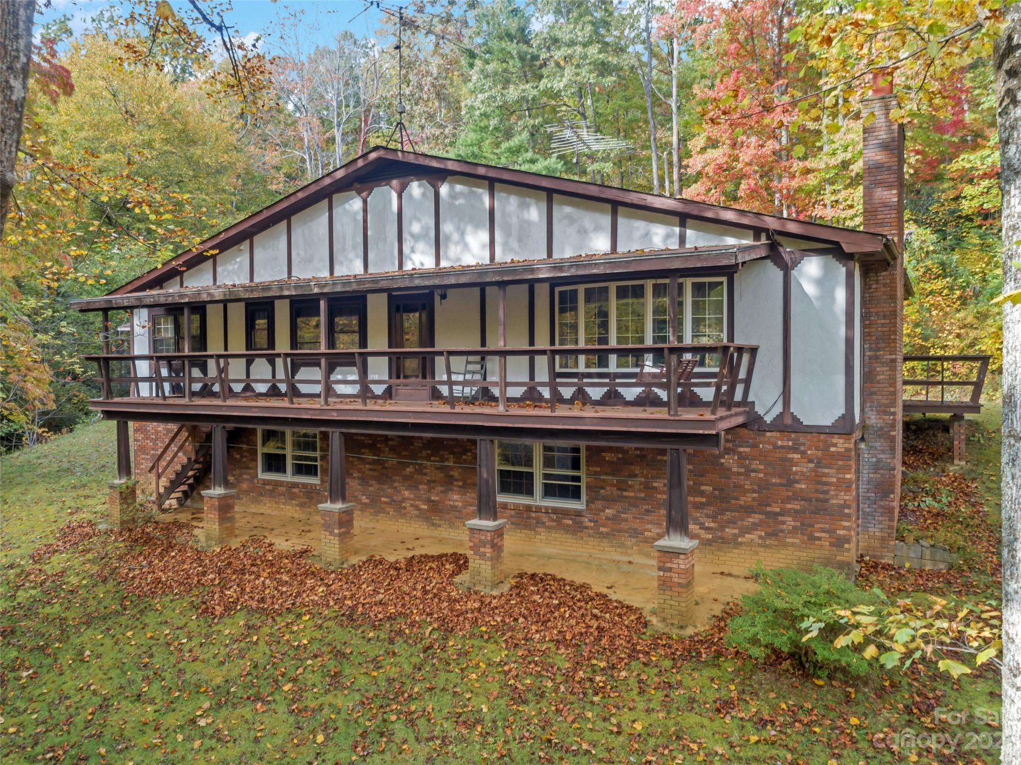 91 Chestnut Hill Road Black Mountain, NC 28711 - Photo 45 of 45 a view of a house with large windows and a yard