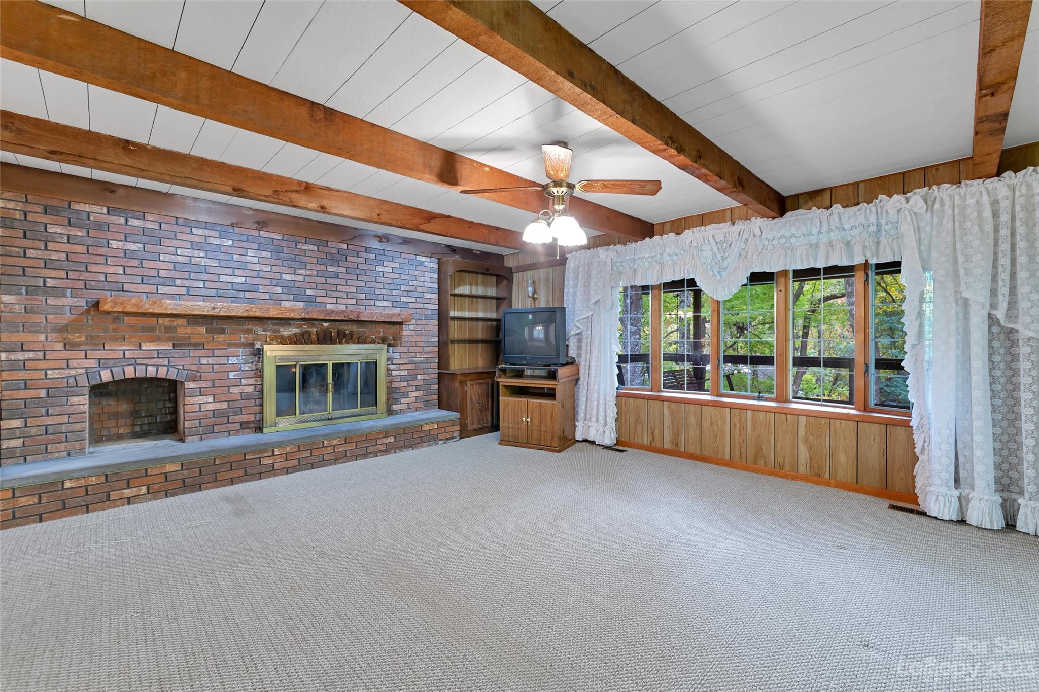 91 Chestnut Hill Road Black Mountain, NC 28711 - Photo 7 of 45 a view of an empty room with a fireplace and a window