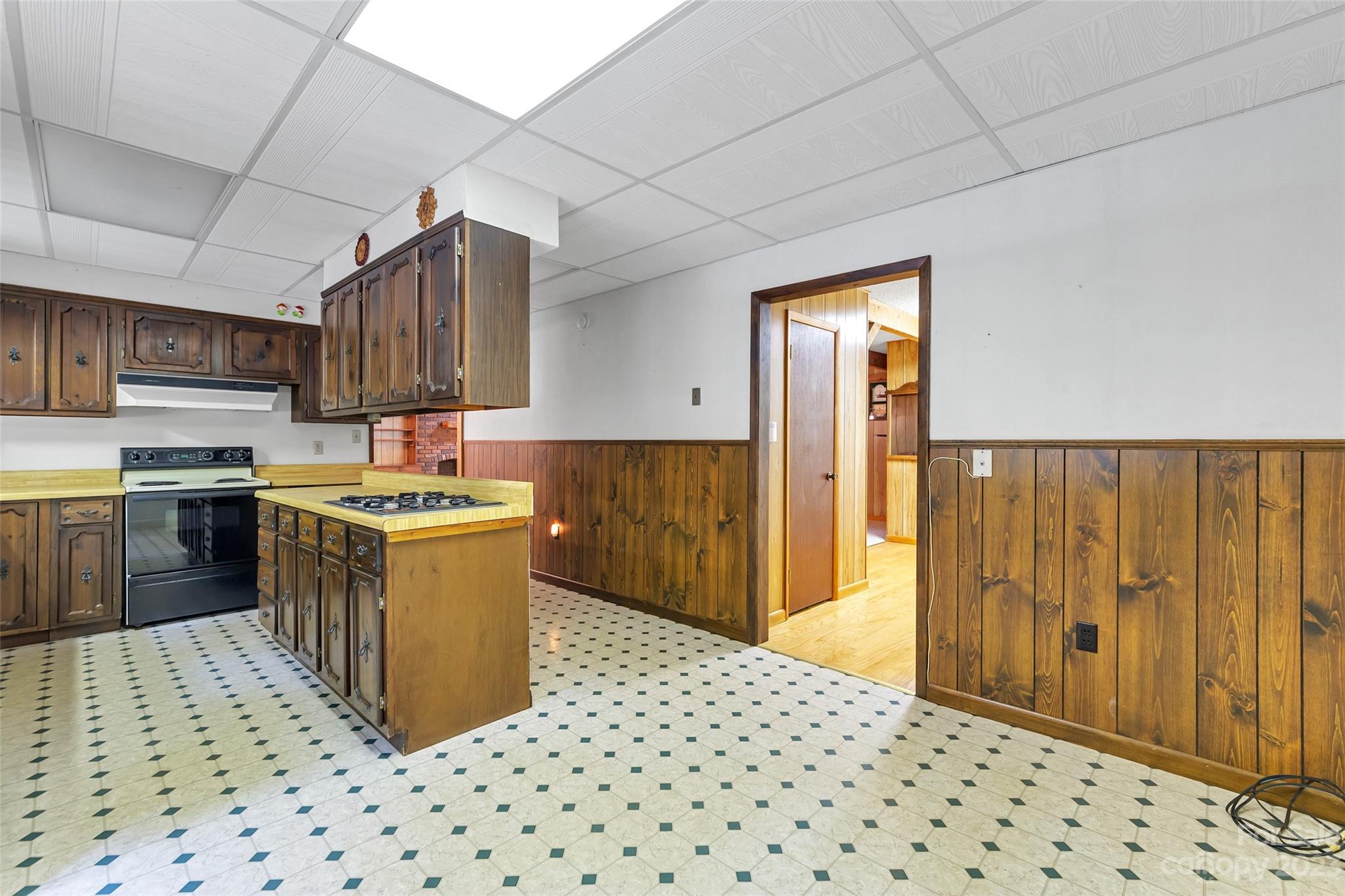 91 Chestnut Hill Road Black Mountain, NC 28711 - Photo 10 of 45 a kitchen with granite countertop a refrigerator and a stove top oven