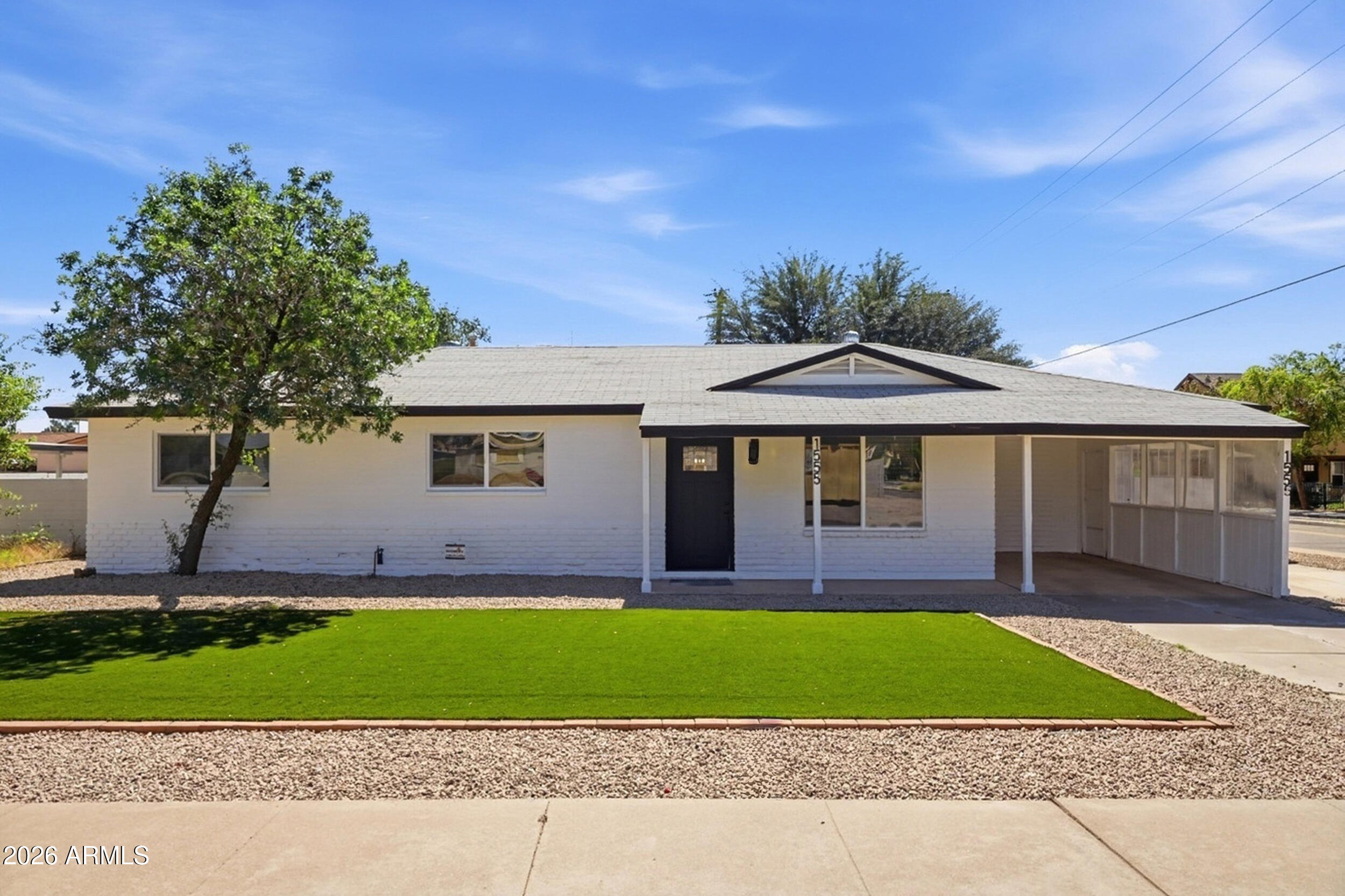 1555 West 6th Street Tempe, AZ 85281 - Photo 1 of 40 a front view of a house with a yard and garage