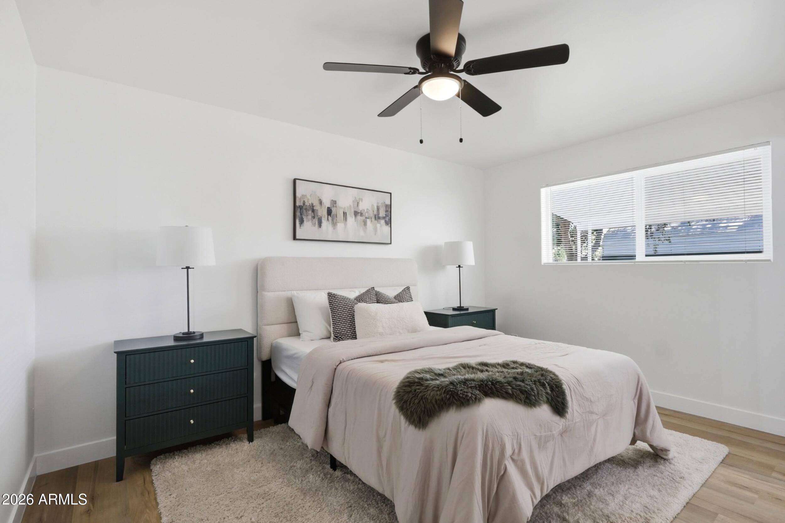 1555 West 6th Street Tempe, AZ 85281 - Photo 13 of 40 a bedroom with a bed and a painting on the wall