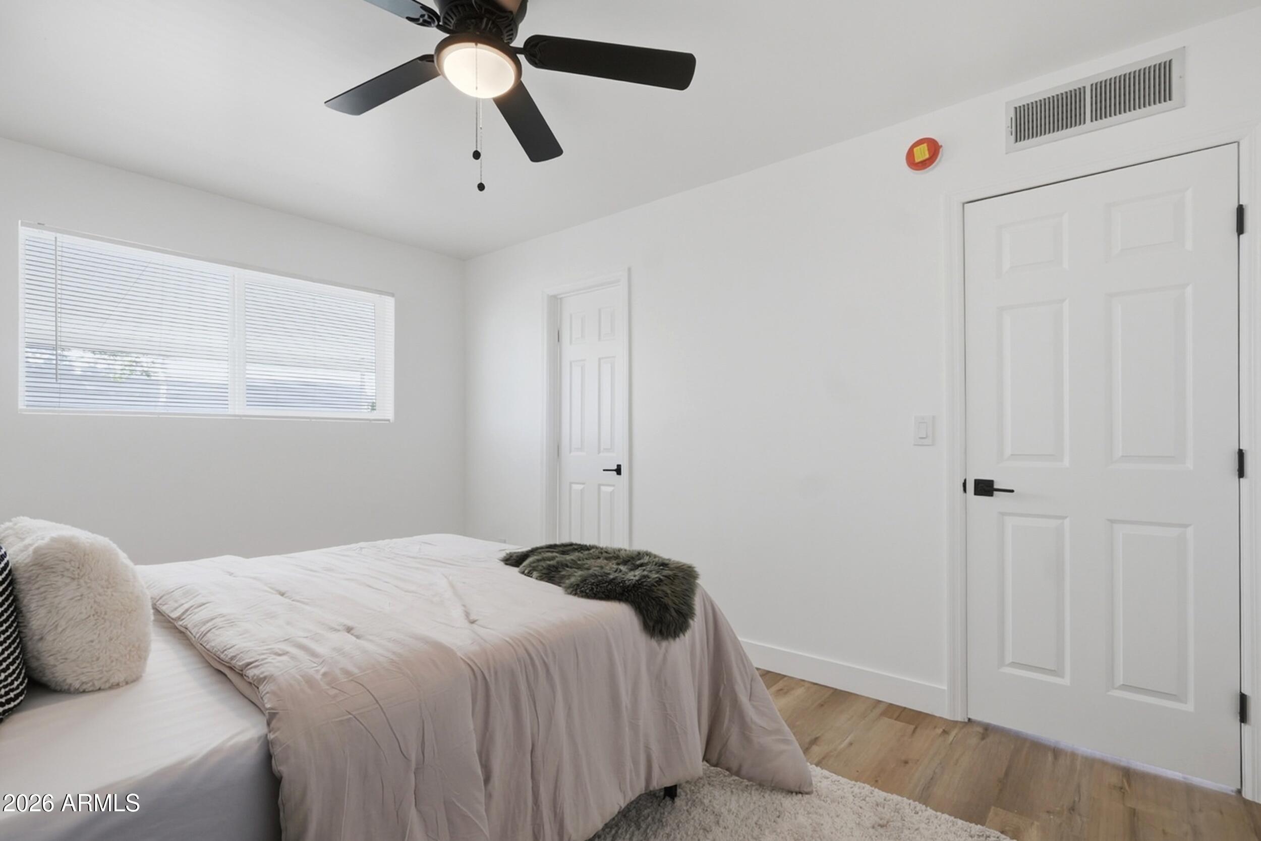1555 West 6th Street Tempe, AZ 85281 - Photo 19 of 40 a bedroom with a bed and a chandelier fan