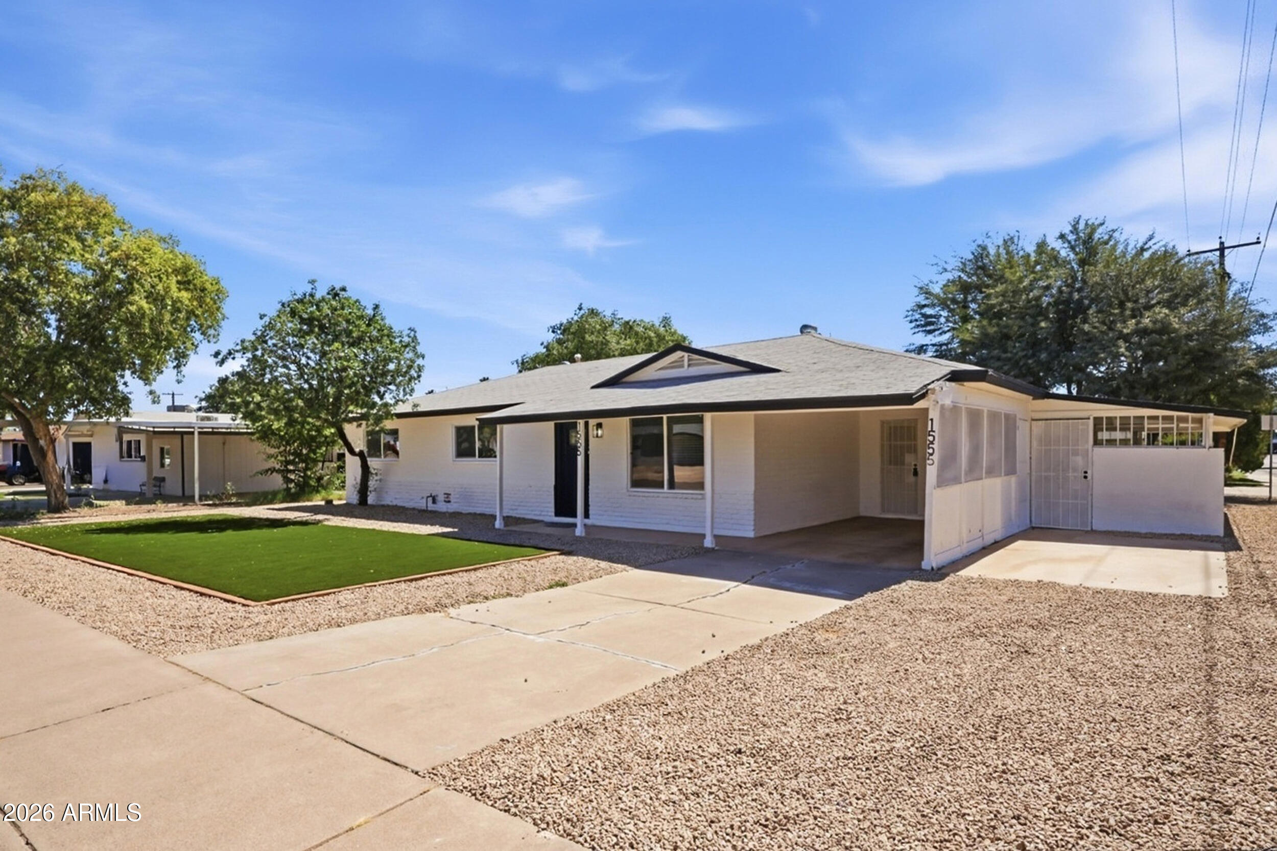 1555 West 6th Street Tempe, AZ 85281 - Photo 2 of 40 a front view of a house with a yard and garage