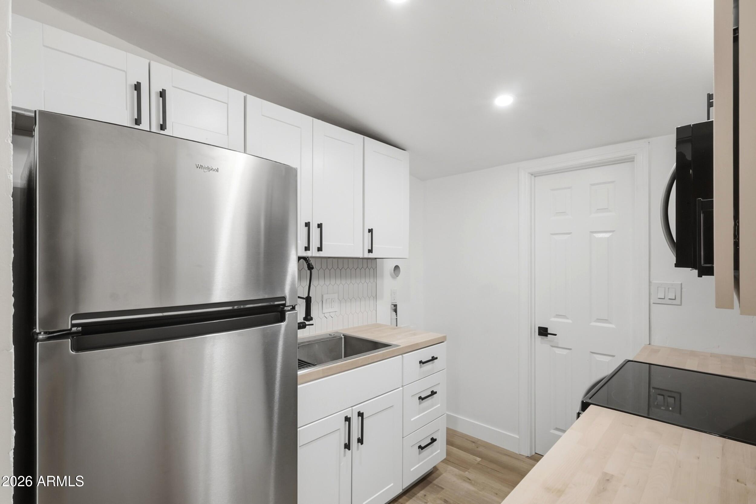 1555 West 6th Street Tempe, AZ 85281 - Photo 22 of 40 a kitchen with a refrigerator and a sink