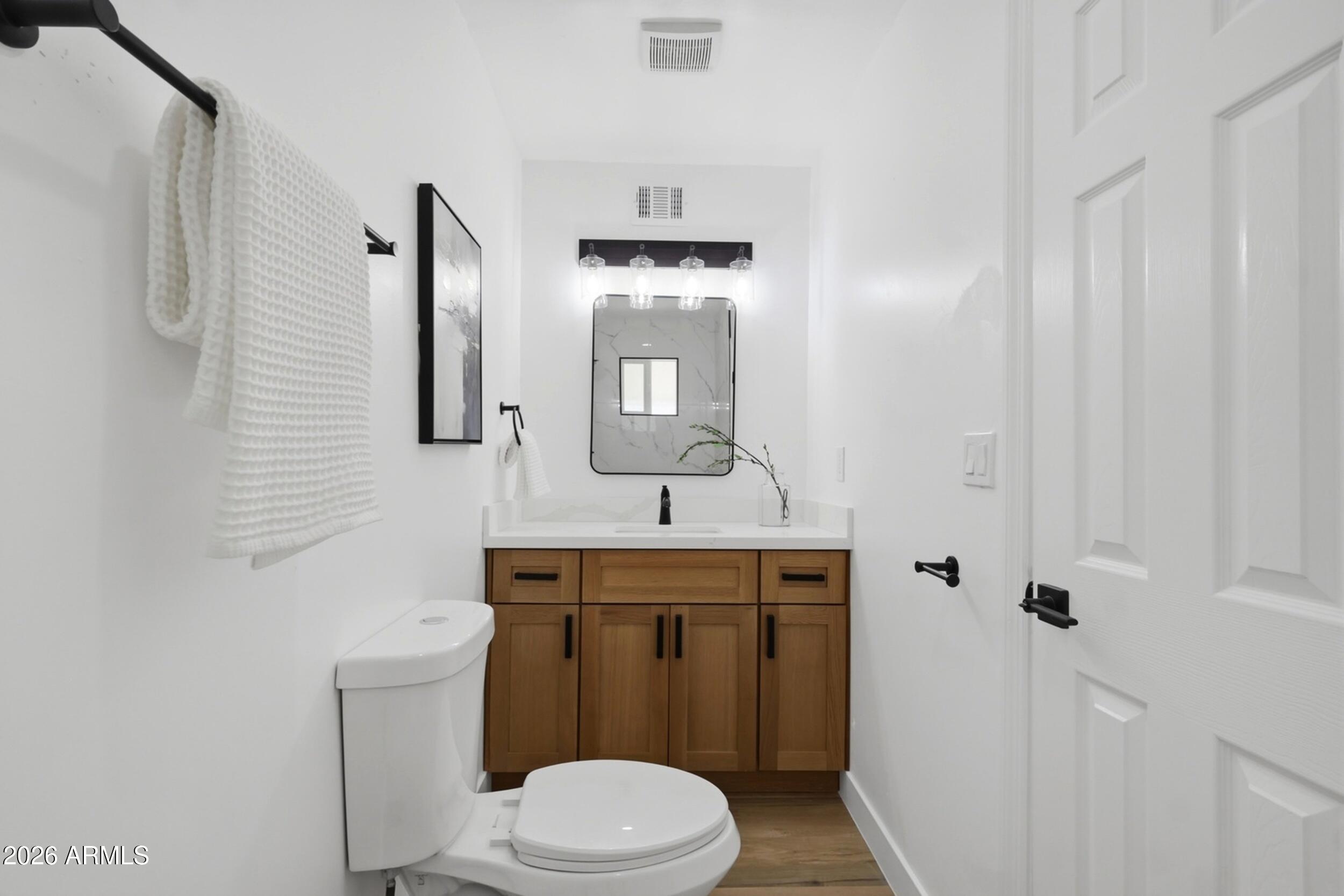 1555 West 6th Street Tempe, AZ 85281 - Photo 26 of 40 a bathroom with a toilet sink vanity and mirror