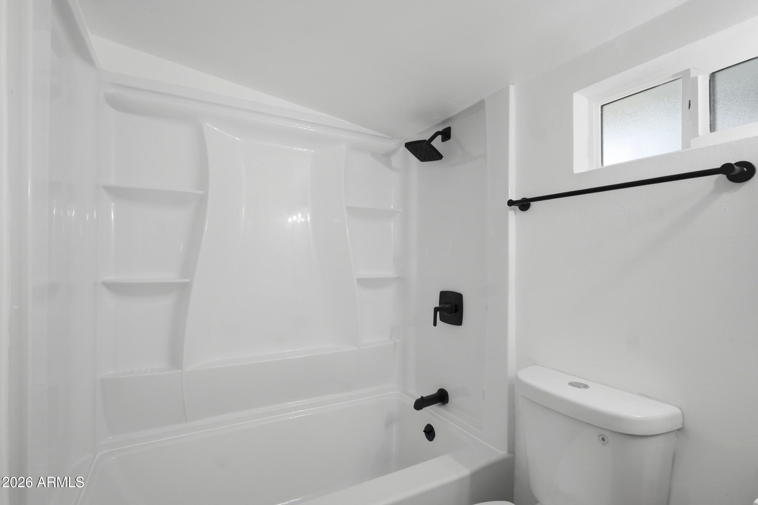 1555 West 6th Street Tempe, AZ 85281 - Photo 28 of 40 a bathroom with a bathtub and a toilet