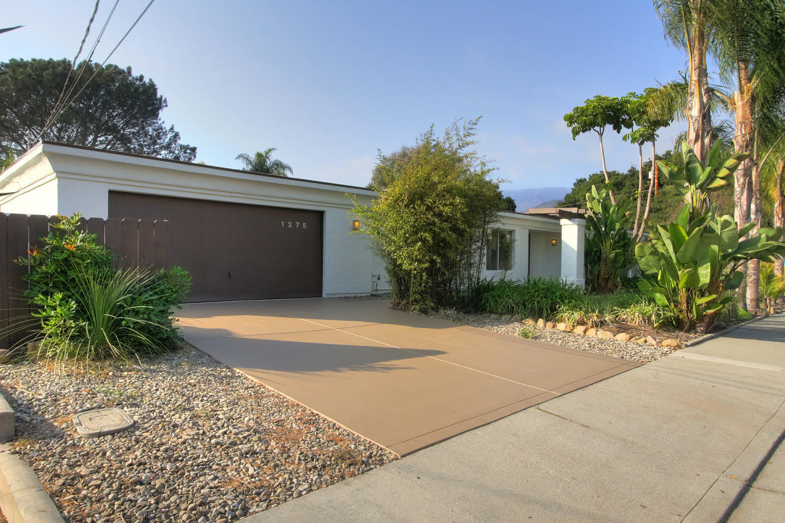 1275 Vallecito Road Carpinteria, CA 93013 - Photo 1 of 11 a front view of a house with a yard and a garage