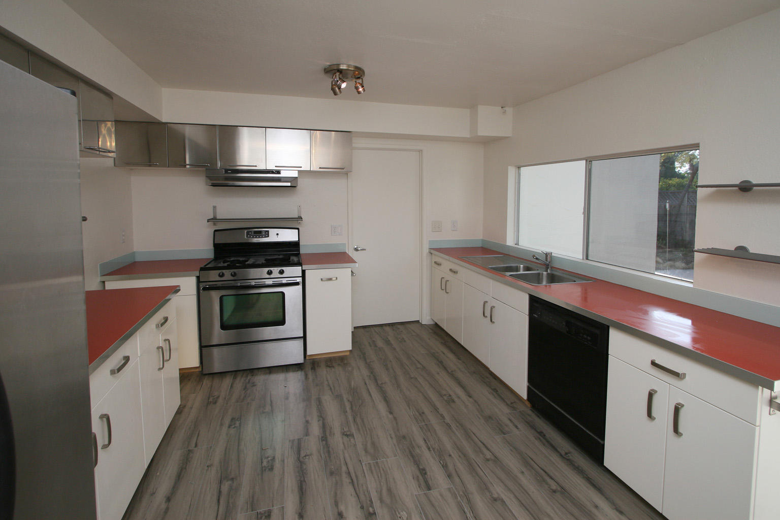 1275 Vallecito Road Carpinteria, CA 93013 - Photo 4 of 11 a kitchen with stainless steel appliances a sink cabinets and wooden floor