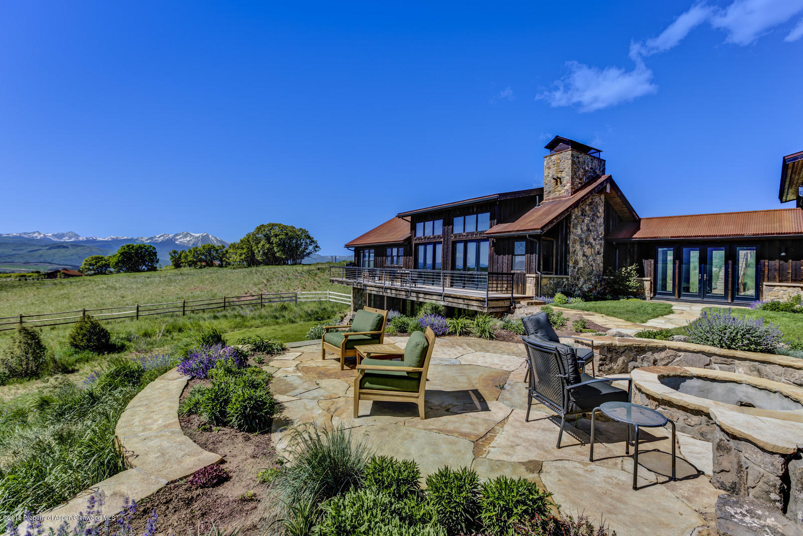 a view of a house with backyard porch and sitting area