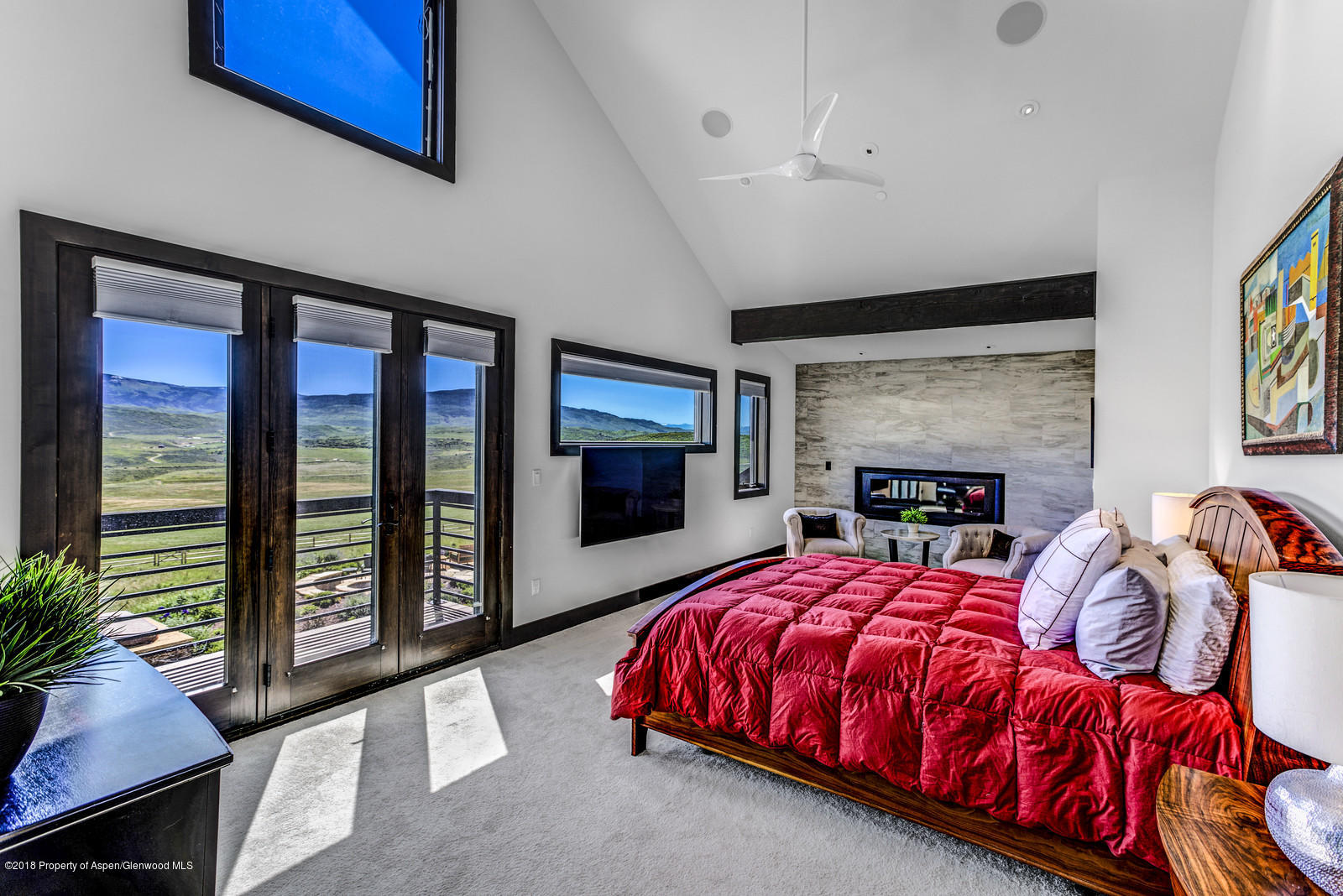 1003 Cattle Creek Ridge Road Carbondale, CO 81623 - Photo 14 of 57 a bedroom with a bed and a flat tv screen next to a window