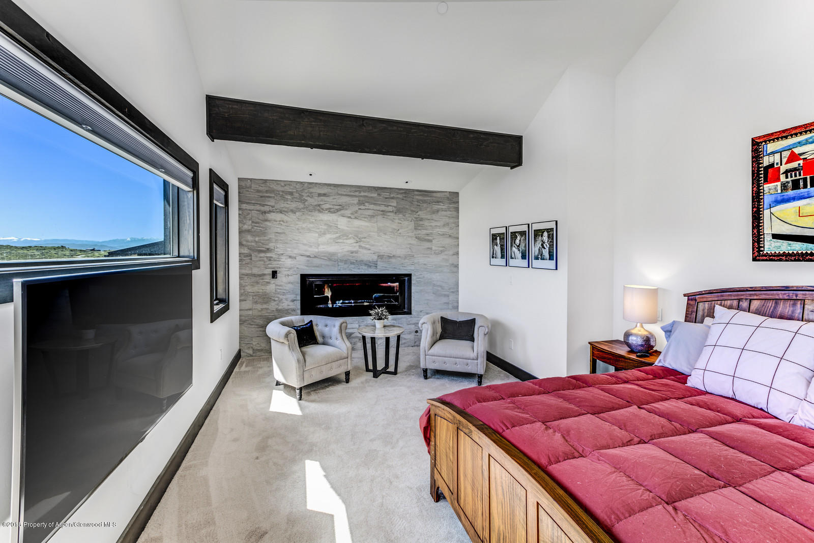 1003 Cattle Creek Ridge Road Carbondale, CO 81623 - Photo 15 of 57 a bed room with a bed and a fireplace