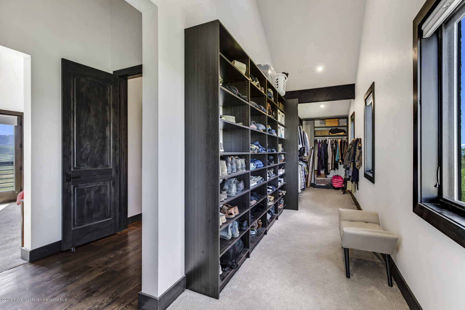 1003 Cattle Creek Ridge Road Carbondale, CO 81623 - Photo 19 of 57 a hallway with wooden floor and furniture