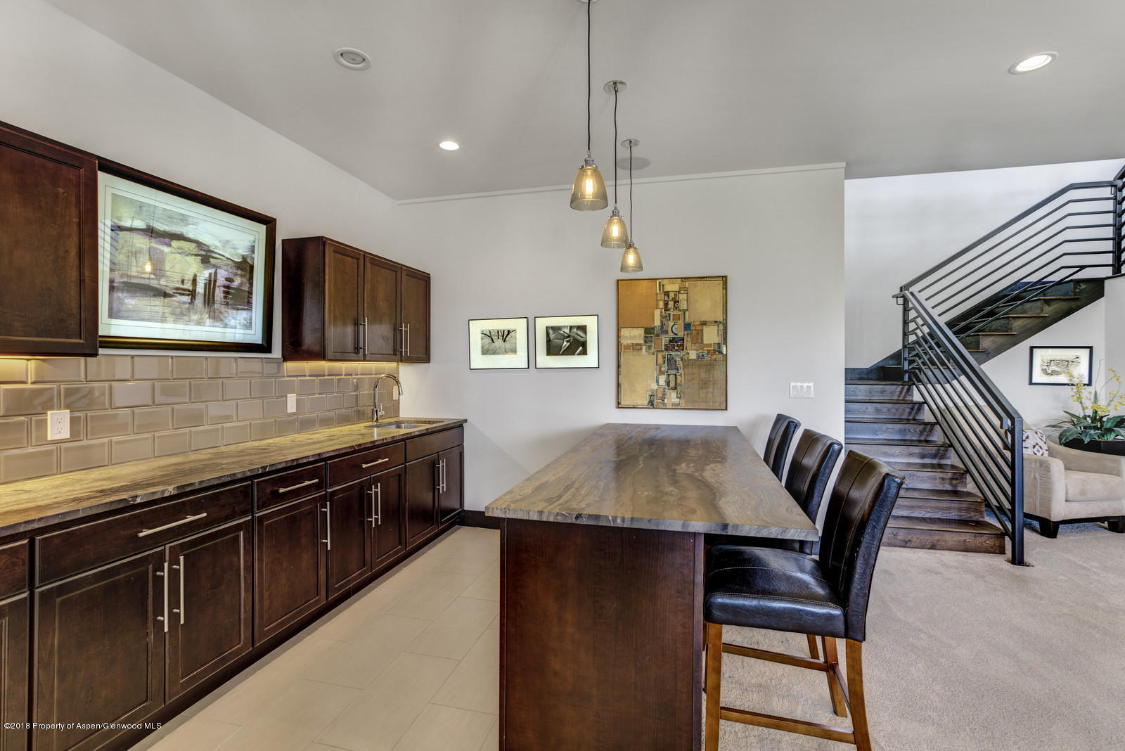 1003 Cattle Creek Ridge Road Carbondale, CO 81623 - Photo 23 of 57 a kitchen with stainless steel appliances granite countertop a stove a sink a microwave a dining table and chairs