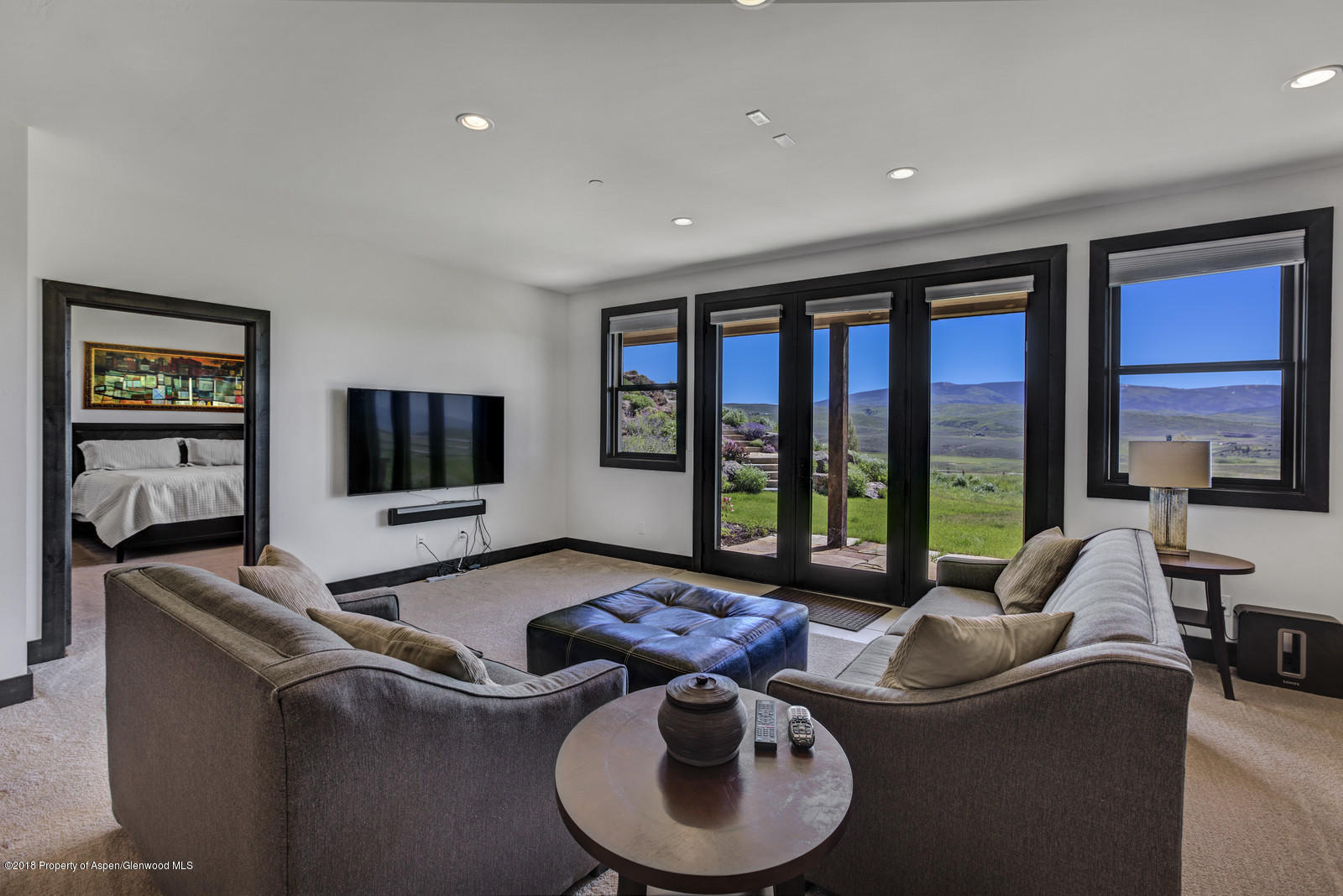 1003 Cattle Creek Ridge Road Carbondale, CO 81623 - Photo 25 of 57 a living room with furniture and a flat screen tv