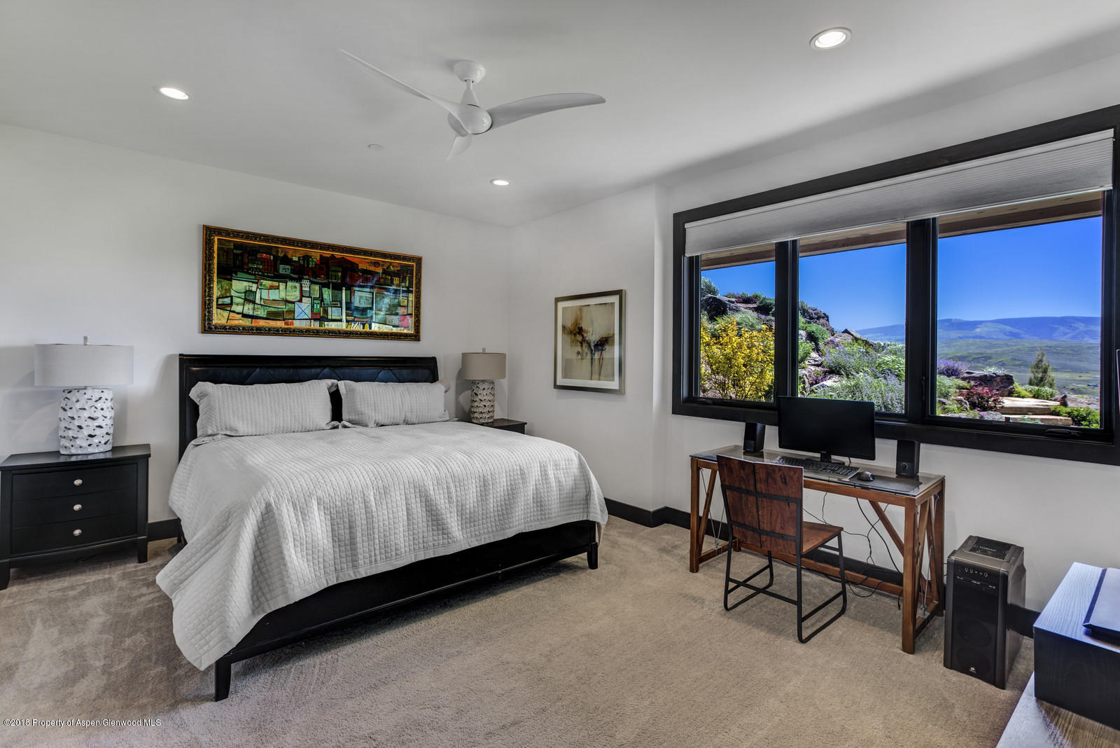 1003 Cattle Creek Ridge Road Carbondale, CO 81623 - Photo 26 of 57 a bedroom with a bed and a flat screen tv