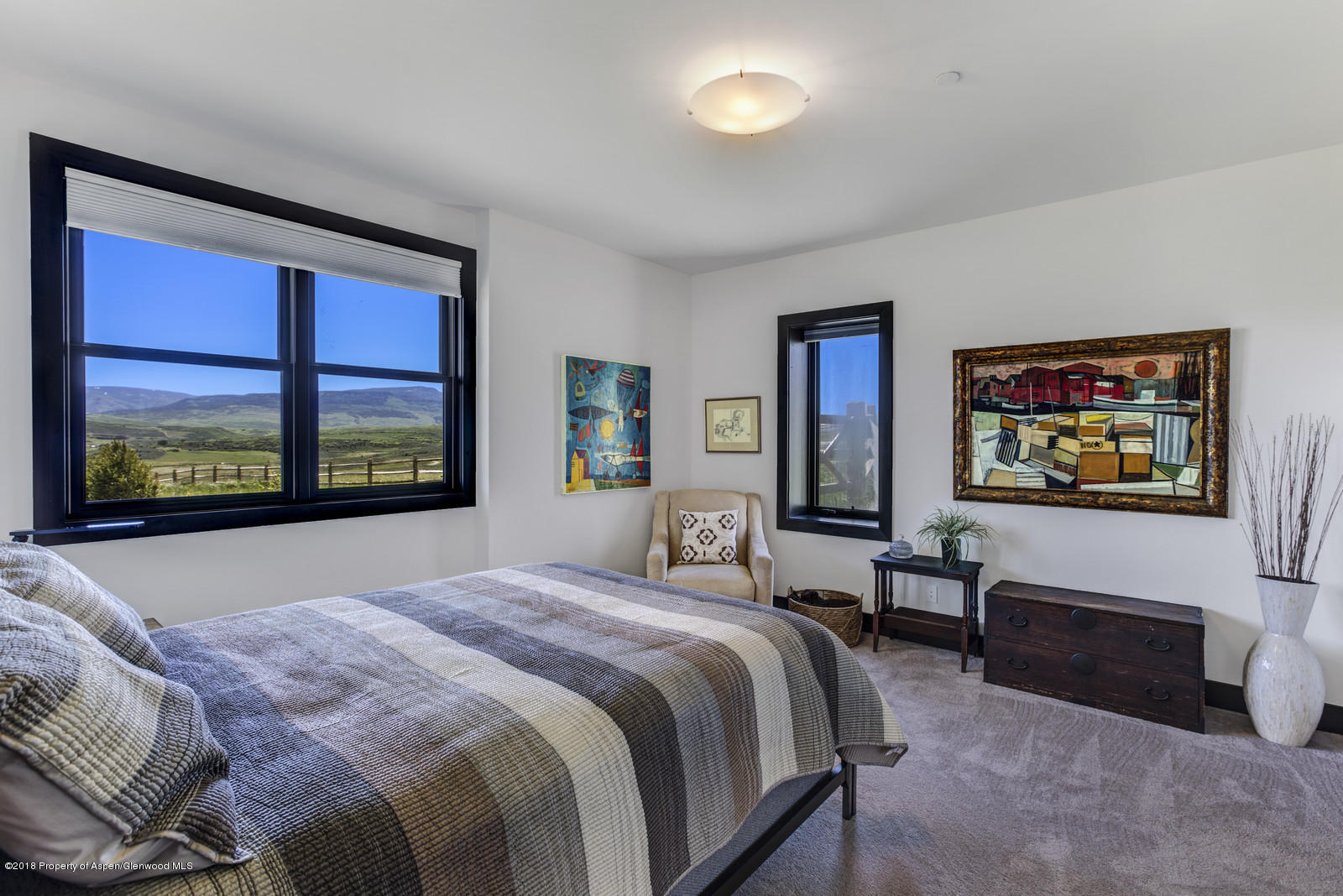 1003 Cattle Creek Ridge Road Carbondale, CO 81623 - Photo 30 of 57 a bedroom with a bed and a dresser next to a window