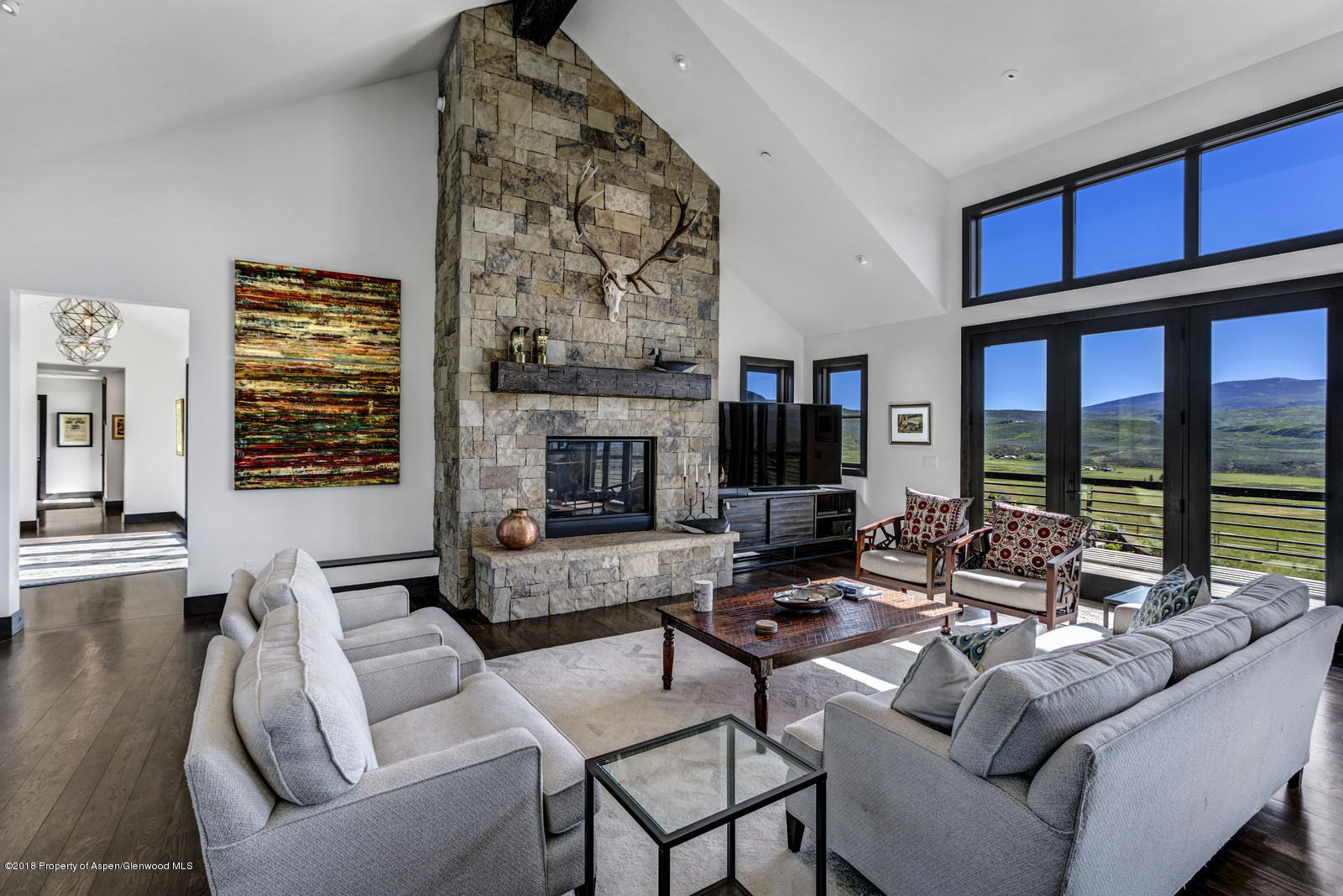 1003 Cattle Creek Ridge Road Carbondale, CO 81623 - Photo 3 of 57 a living room with furniture large window and a fireplace