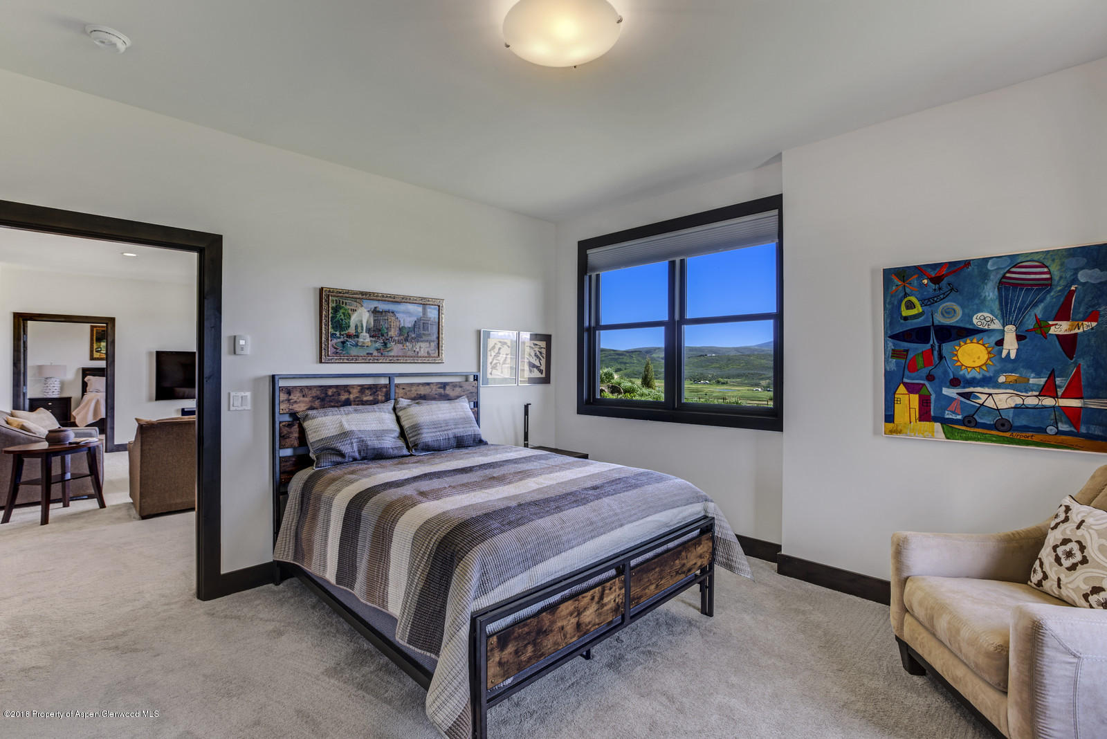 1003 Cattle Creek Ridge Road Carbondale, CO 81623 - Photo 31 of 57 a bedroom with a bed and a painting on the wall