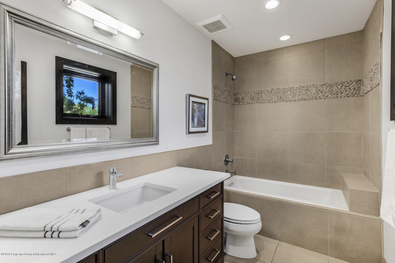 1003 Cattle Creek Ridge Road Carbondale, CO 81623 - Photo 33 of 57 a bathroom with a sink a toilet a mirror a vanity and bathtub