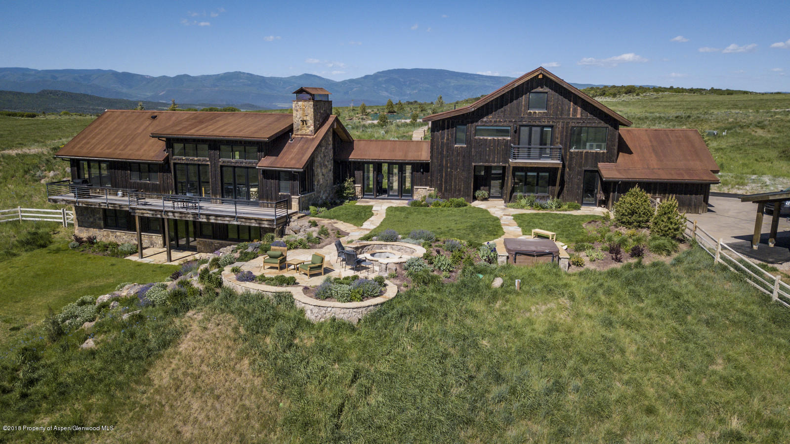1003 Cattle Creek Ridge Road Carbondale, CO 81623 - Photo 53 of 57 a front view of a house with a yard table and chairs