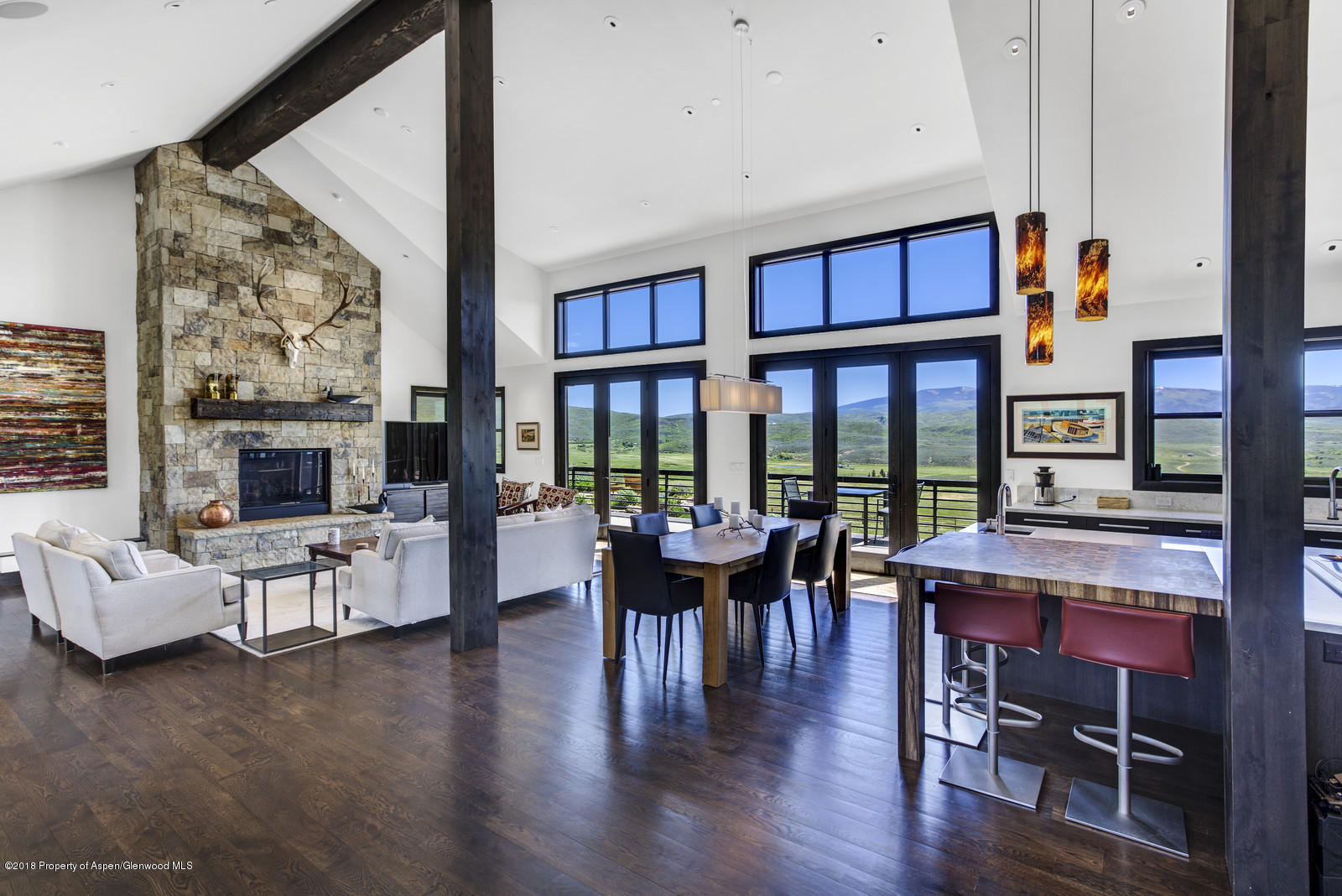 1003 Cattle Creek Ridge Road Carbondale, CO 81623 - Photo 6 of 57 a living room with furniture and large windows