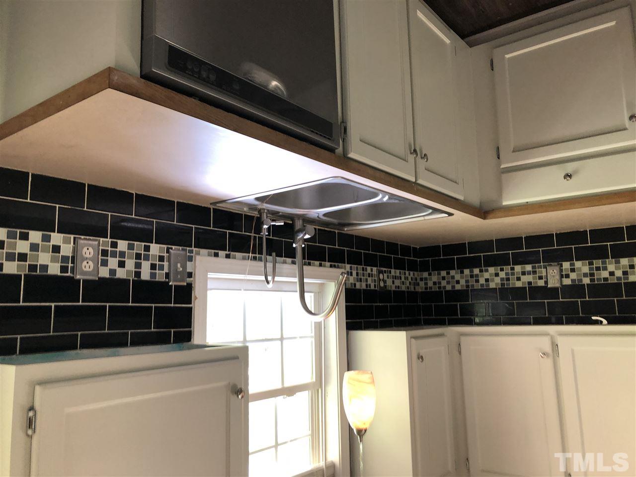 2518 Siler Road Snow Camp, NC 27349 - Photo 6 of 24 Dishwasher and pendant lighting compliment tile back splash.