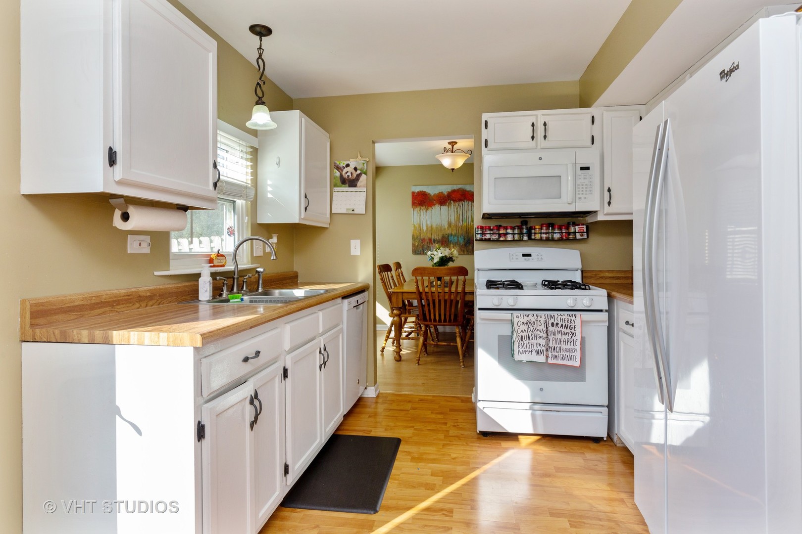 1031 Perry Drive Algonquin, IL 60102 - Photo 6 of 10 a kitchen with stainless steel appliances a stove a refrigerator a sink a stove and white cabinets with wooden floor