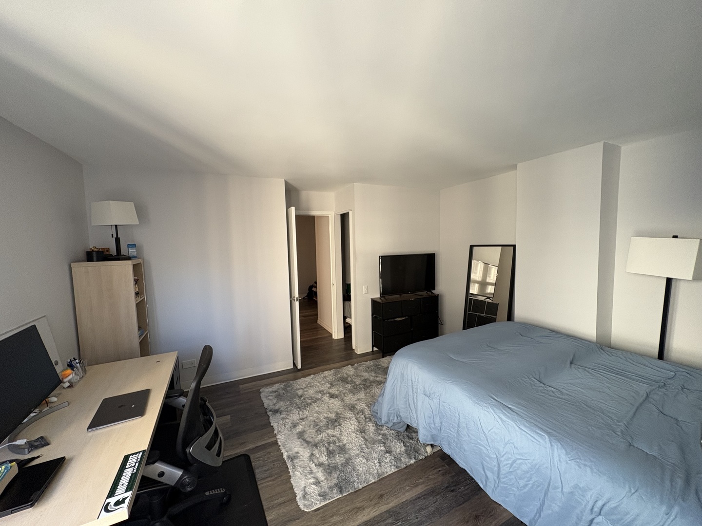 8 West Chestnut Street, Unit 21F Chicago, IL 60610 - Photo 13 of 19 a bedroom with a bed and wooden floor