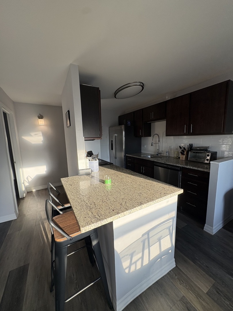 8 West Chestnut Street, Unit 21F Chicago, IL 60610 - Photo 6 of 19 a kitchen with stainless steel appliances granite countertop a sink stove and refrigerator