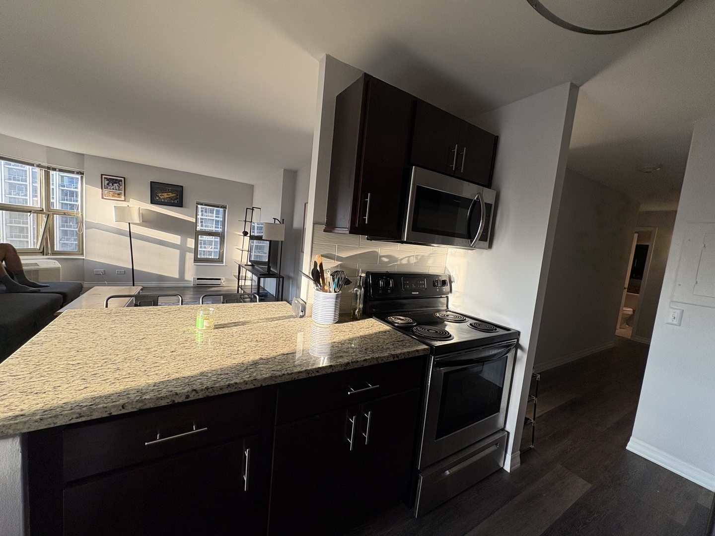 8 West Chestnut Street, Unit 21F Chicago, IL 60610 - Photo 8 of 19 a kitchen with granite countertop a sink a stove and cabinets