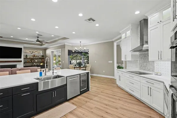 a large kitchen with stainless steel appliances lots of counter space and wooden floor