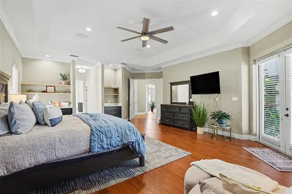 a bedroom with a bed window and a flat screen television