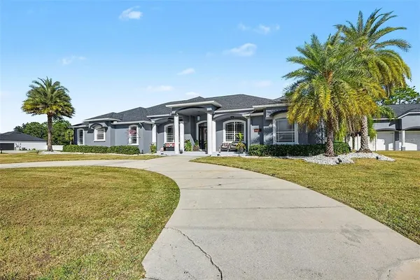 a front view of house with yard and green space