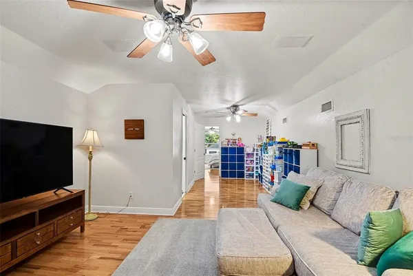 a living room with furniture and a chandelier