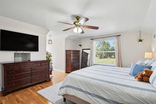 a bedroom with a large bed and a chandelier
